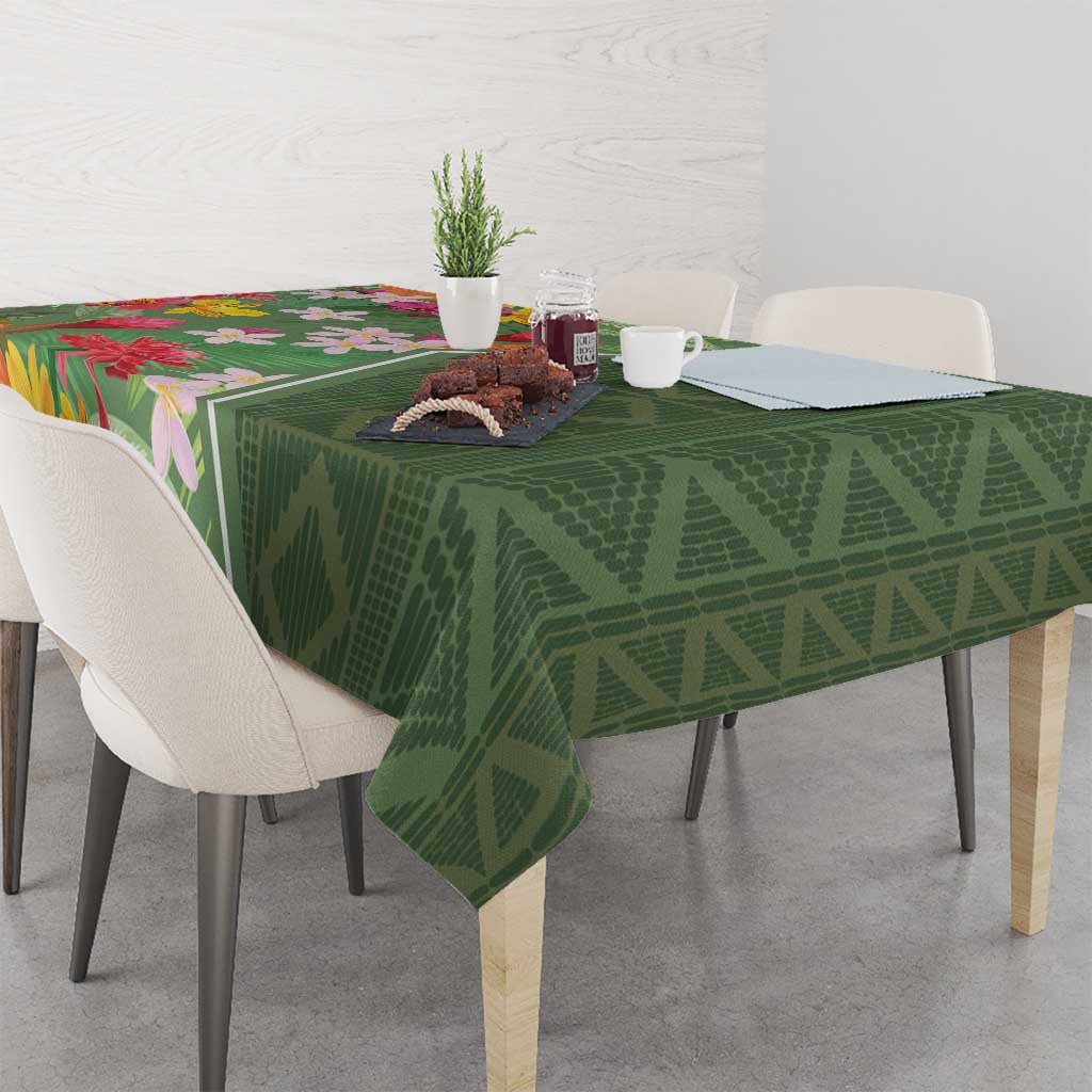 Green tropical floral tablecloth with textured diamond pattern across dining table