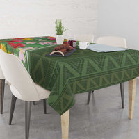 Green tropical floral tablecloth with textured diamond pattern across dining table