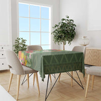 Green tropical floral tablecloth on dining table with multicolor flower panel
