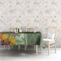 Green tropical floral tablecloth with leaf-and-flower print on dining table