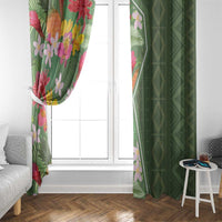 Green geometric curtain panel and floral panel framing a window with curtains tied back