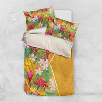 Yellow tropical floral bedding set laid flat with two pillowcases and duvet cover
