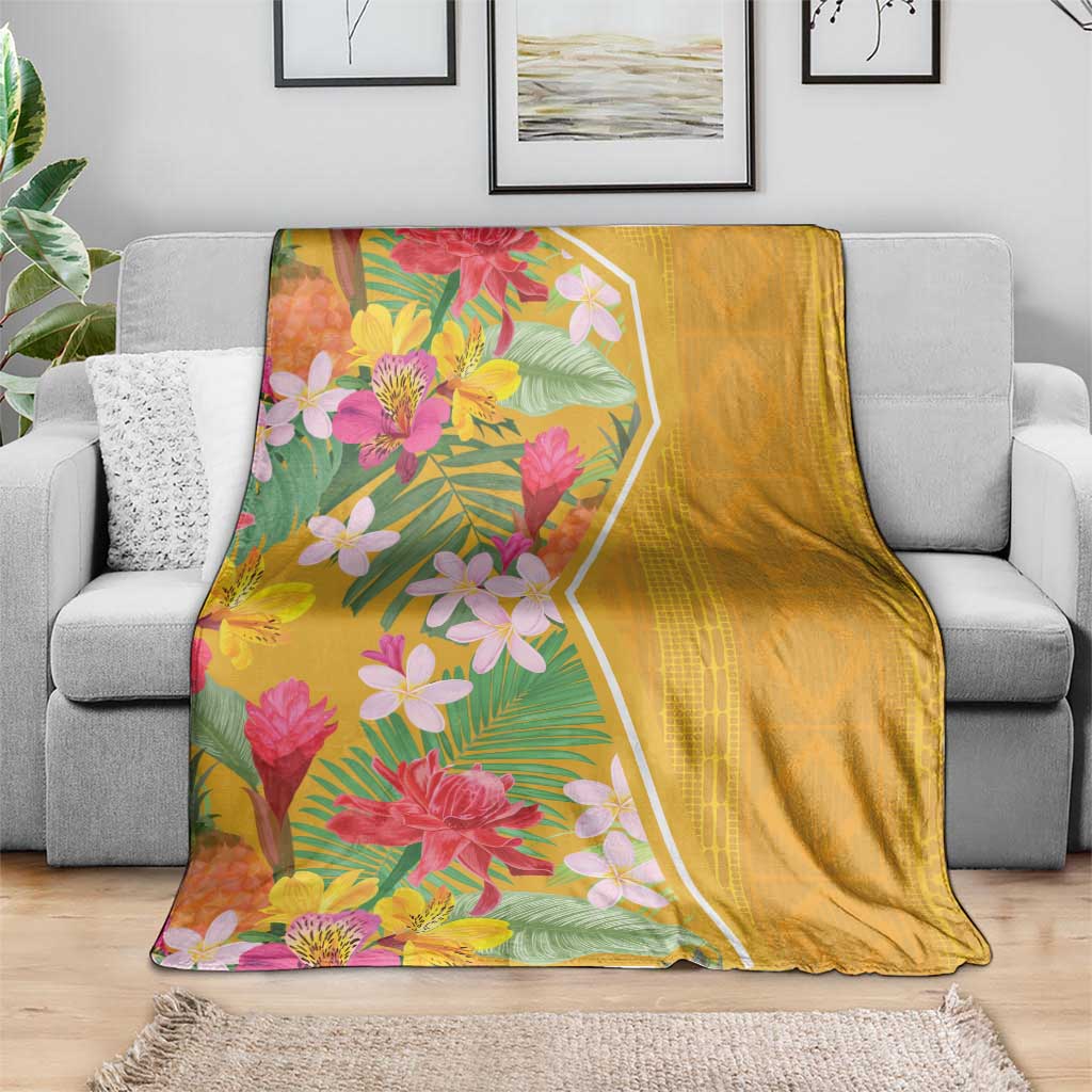 Yellow tropical flower blanket on grey sofa, floral print on one side and solid back