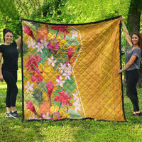 Yellow quilt blanket with diamond stitching and vibrant tropical flower print, dark edge trim