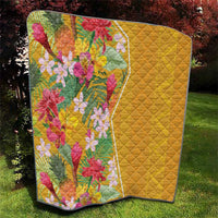 Yellow floral quilt with diamond quilting texture and tropical flower design, dark binding