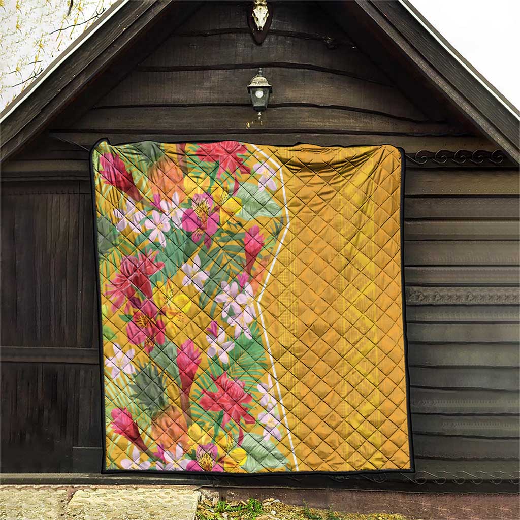 Yellow quilt with diamond quilting and colorful tropical flowers, dark-trimmed edges