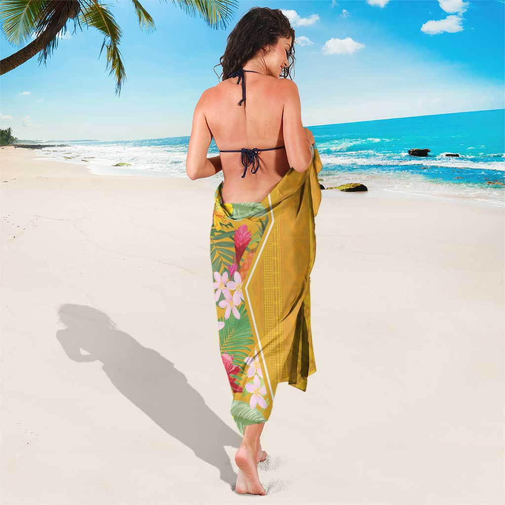 Yellow beach sarong draped to mid-calf with tropical blooms on one side
