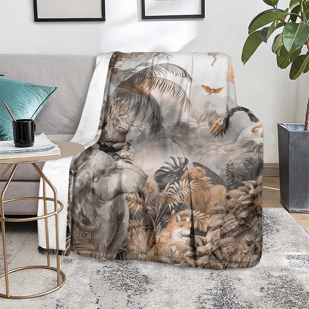 Grey safari animal throw blanket leaning on chair, showing elephant, lion and leaf print