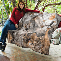 Grey safari animal quilt with quilted diamonds, draped over outdoor seating