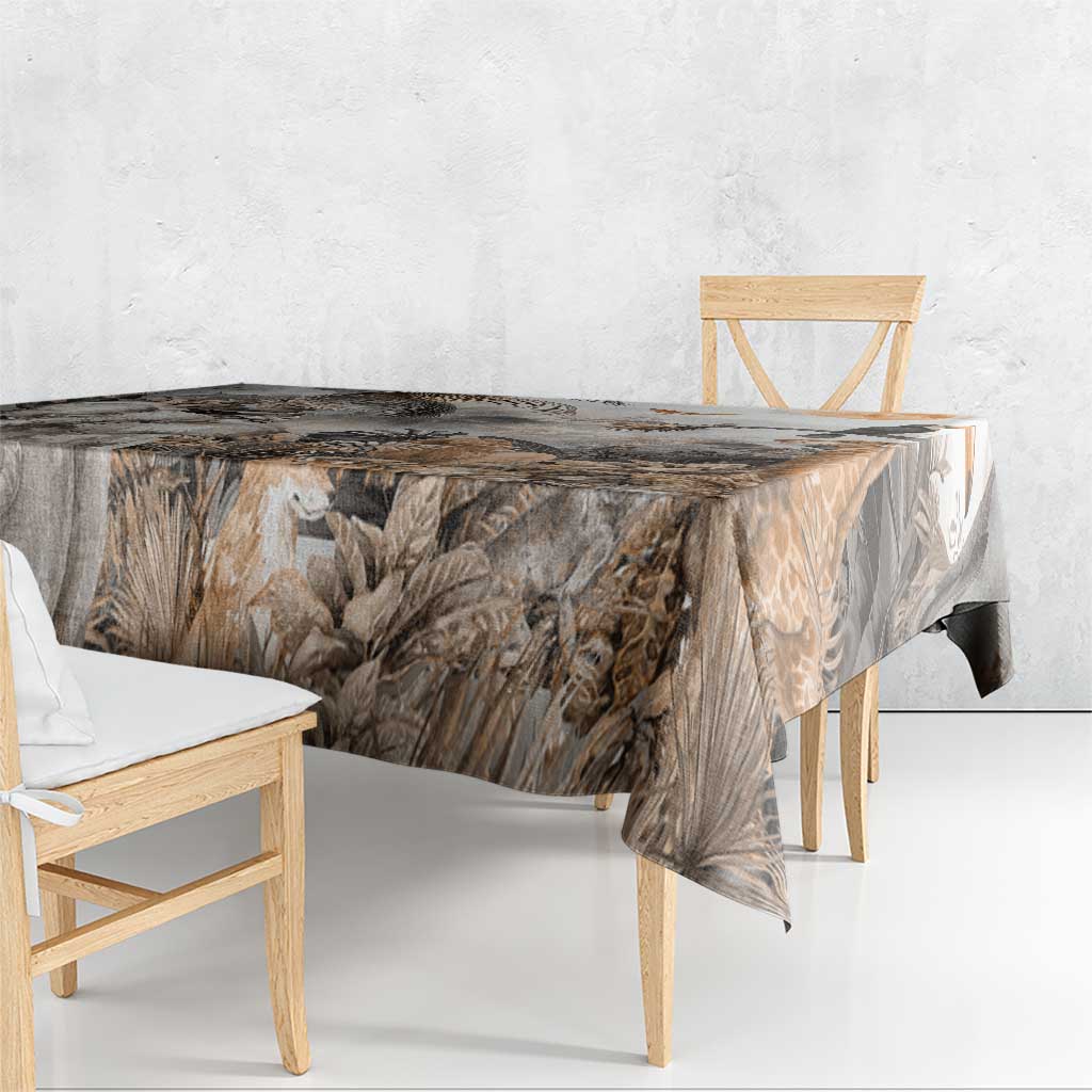 Grey safari animal tablecloth draped over table with jungle leaves and wildlife