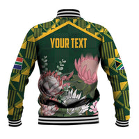 Green baseball jacket with kente-pattern sleeves, floral back print, 'YOUR TEXT' top
