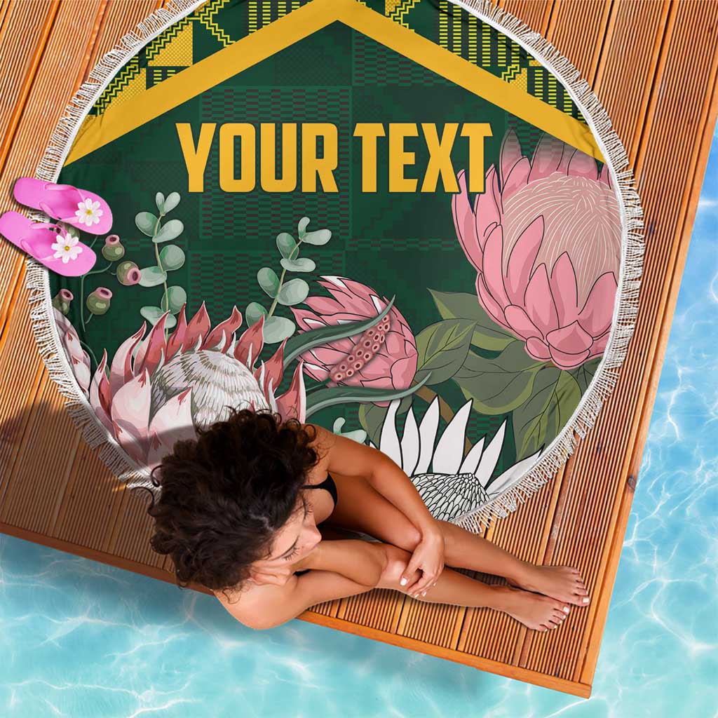 Green round beach blanket with tropical animals and flowers, yellow Kente border, fringed edge