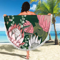 Green round beach blanket with tropical flowers and animals, yellow Kente border, fringed edge