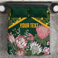 Green personalized duvet cover set with yellow kente pattern and pink protea florals, 'YOUR TEXT'