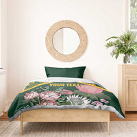 Green personalized duvet cover set with yellow kente pattern and pink protea florals, 'YOUR TEXT'