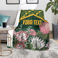 Personalized green blanket with kente pattern band and protea floral artwork