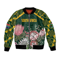 Green bomber jacket with kente-pattern sleeves, floral protea front, front zipper