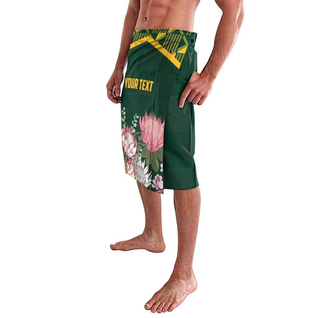 Green lavalava sarong skirt with kente band and floral graphic panel, "YOUR TEXT" front