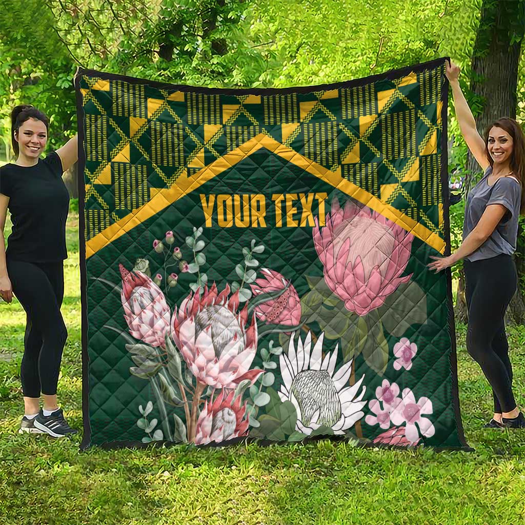 Green personalized quilt with yellow kente border, protea flowers, and “YOUR TEXT”