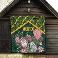 Green quilt featuring yellow kente border with pink protea flowers and “YOUR TEXT”