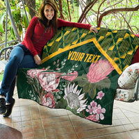 Green personalized quilt with yellow kente border and protea floral design