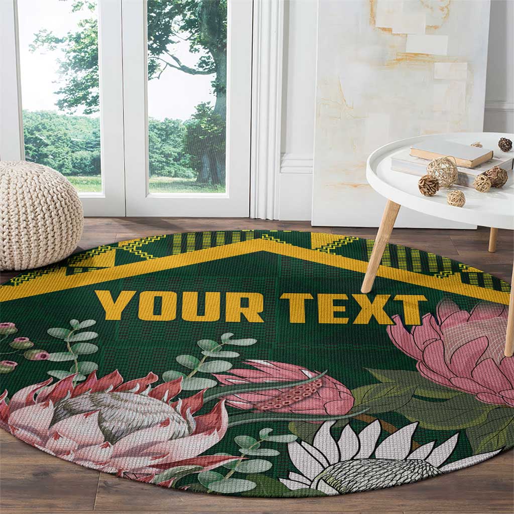 Green round rug with gold kente trim and protea, fish, and plant pattern with custom text