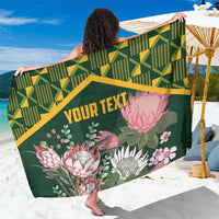 Green protea floral sarong with kente geometric band and custom text, draped panel