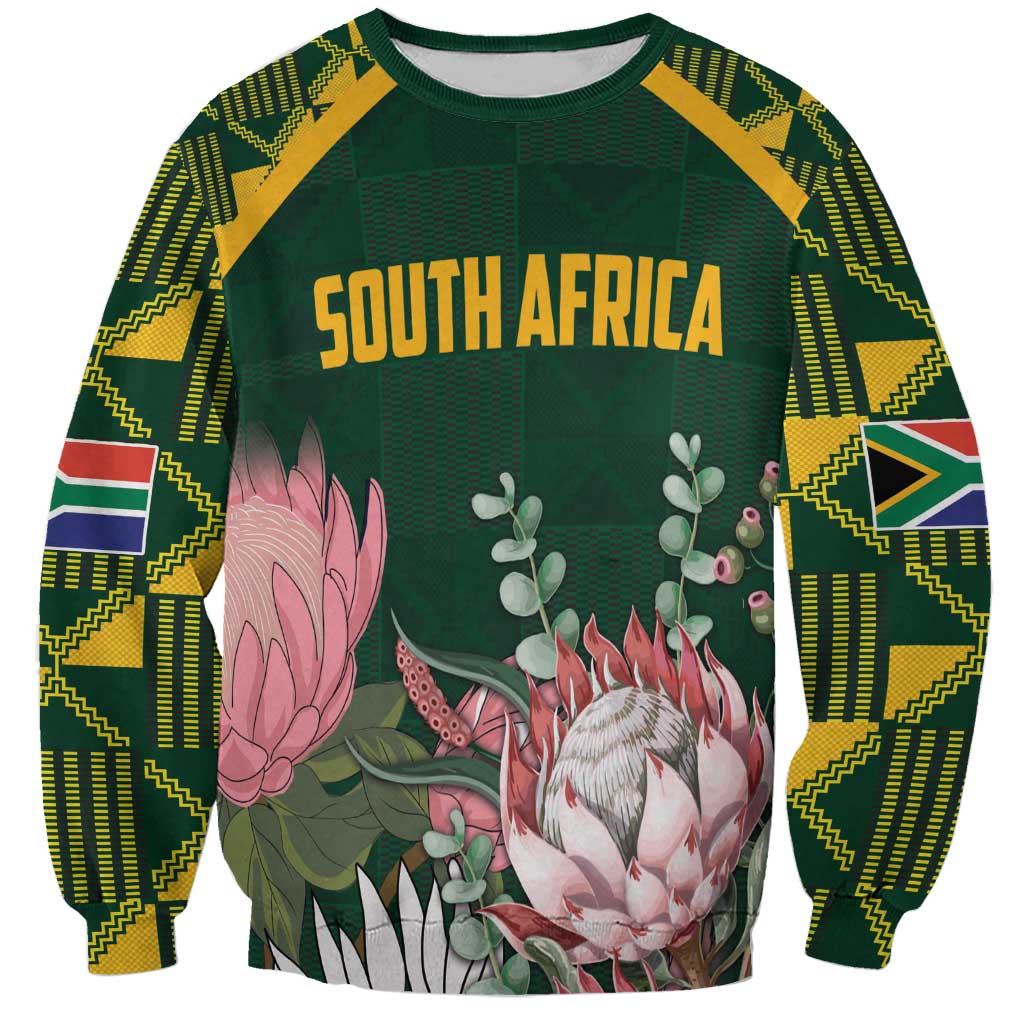 Green unisex sweatshirt with Kente-pattern sleeves and floral protea graphic, “SOUTH AFRICA”