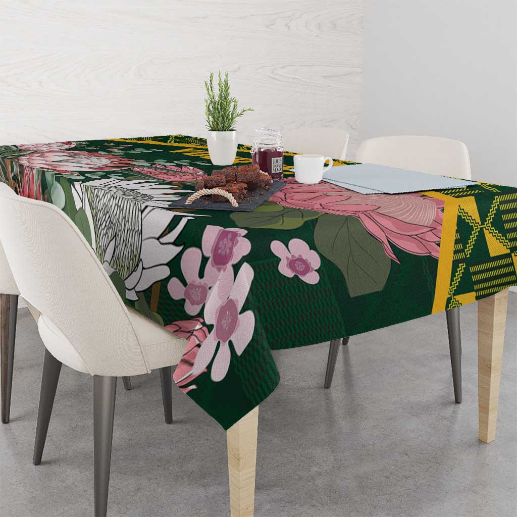 Green floral tablecloth with birds and flowers, yellow Kente-style border on dining table