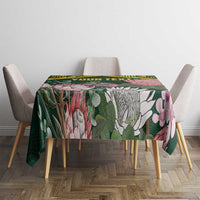 Green tablecloth with floral pattern, yellow Kente-style border, and 'YOUR TEXT' on table