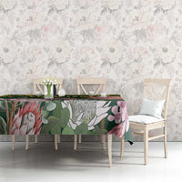 Green floral tablecloth with birds and leaves pattern, yellow Kente-style border
