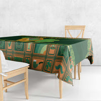 Green Irish tablecloth with harp and shamrock border, draped over bench edge