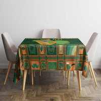Green Irish tablecloth with harp and shamrock motifs on dining table