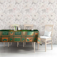 Green Irish tablecloth with harp and shamrock motifs on long dining table