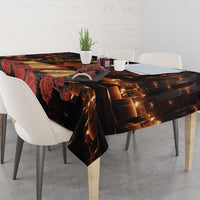 Black St. Lucy tablecloth on dining table with warm candle flames and red rose details