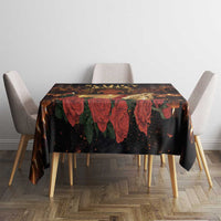 Black St. Lucy tablecloth on square table with repeating red flower and green vine accents
