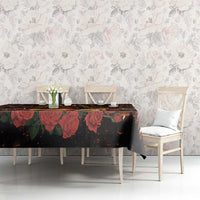 Black St. Lucy tablecloth on long table with red tulip pattern and candlelit scene elements