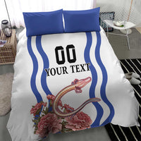 White bedding set with blue wavy border stripes, black “00” and “YOUR TEXT”, pink blooms