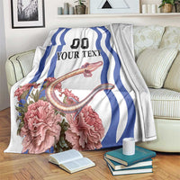 White blanket with blue wavy stripes, pink carnation flowers, and “YOUR TEXT” design