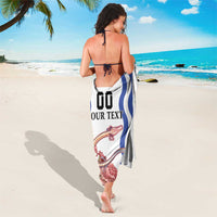 White sarong with blue wave stripes, red dragon and pink flowers, tied at waist