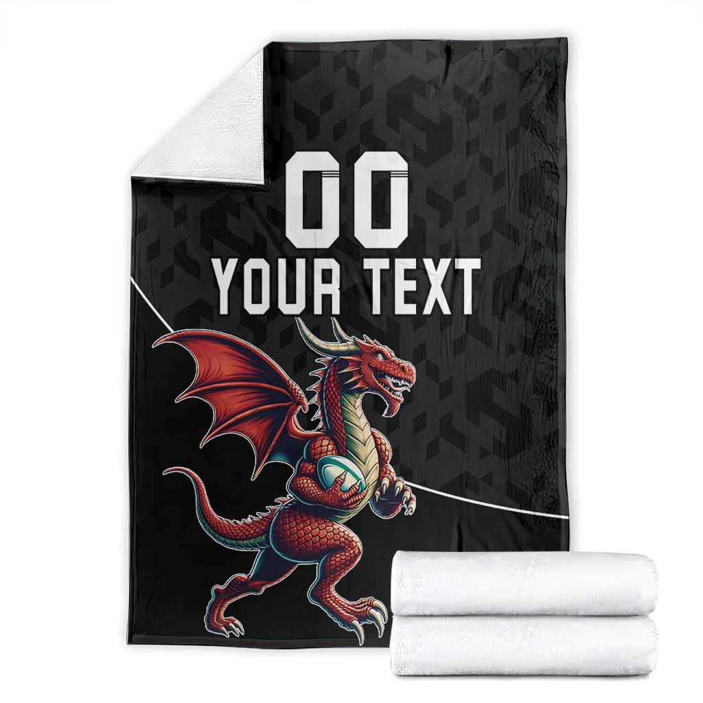 Black rugby blanket with '00 YOUR TEXT' and red dragon mascot, folded with white rolls