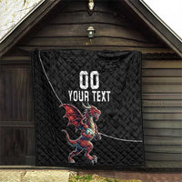 Black quilted blanket with Welsh dragon mascot and custom text, hanging outdoors