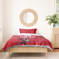Red duvet with dragon mascot and white "DO YOUR TEXT" print, two pillows