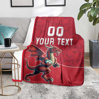 Red rugby blanket over a chair with dragon mascot graphic and "YOUR TEXT" lettering