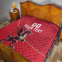 Red quilt blanket on a bed with Welsh dragon graphic and 'YOUR TEXT' lettering.