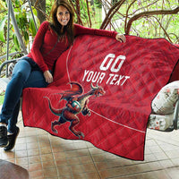 Red quilt blanket with Welsh dragon mascot and 'YOUR TEXT' text, laid on patio.
