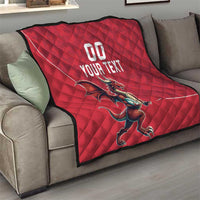 Red quilt blanket draped on a sofa with Welsh dragon graphic and 'YOUR TEXT'.