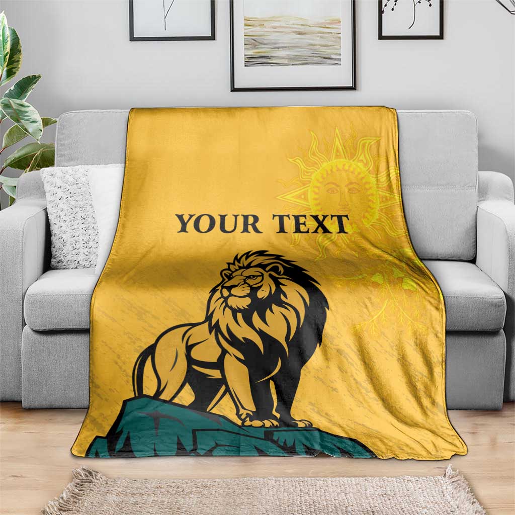 Yellow lion graphic personalized blanket on gray sofa with 'YOUR TEXT' and sun face