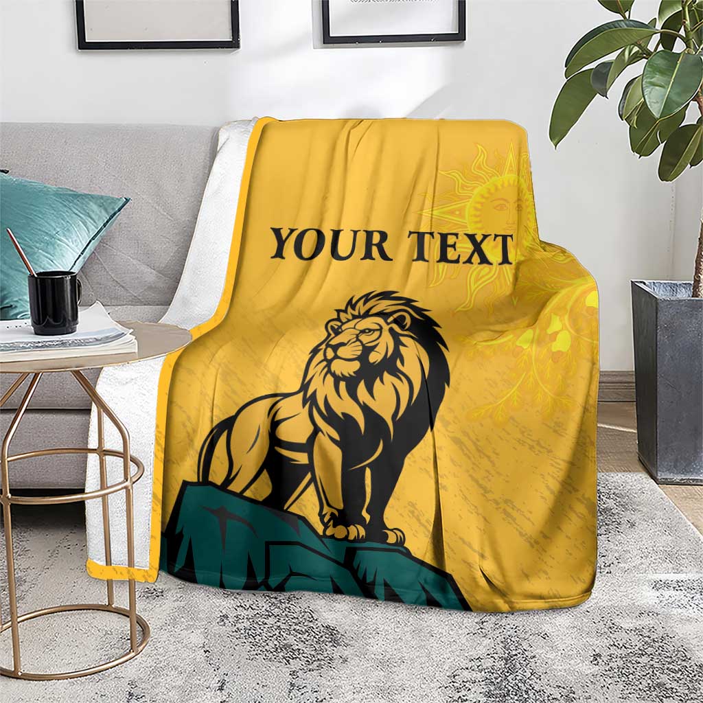 Yellow lion graphic personalized blanket over gray chair with 'YOUR TEXT' and sun face