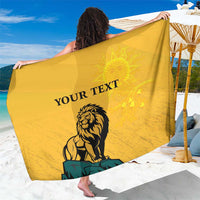 Yellow personalized sarong with lion and sun face graphic, 'YOUR TEXT' centered